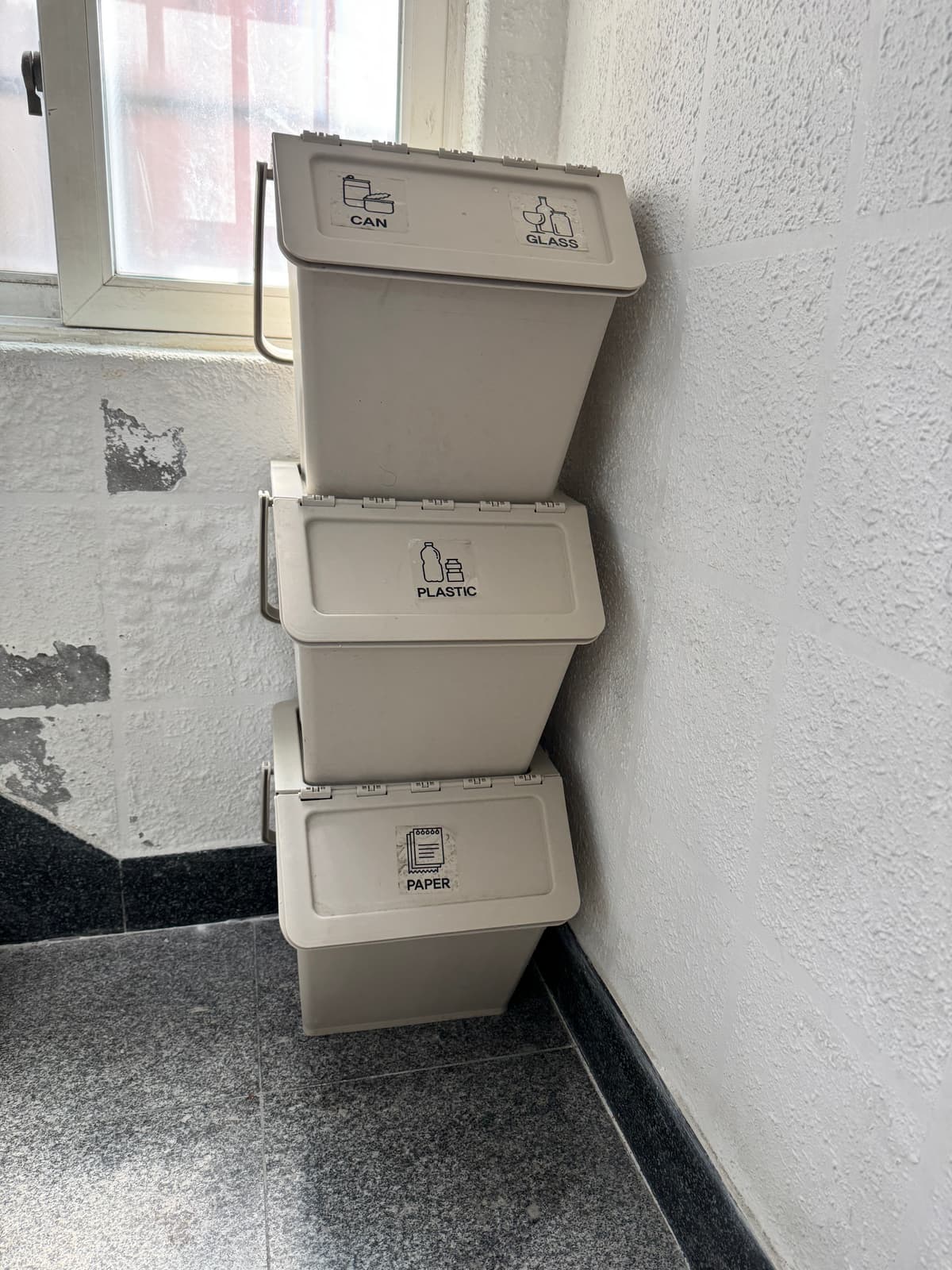 Recycling bins between the 3rd and 4th floor stairs